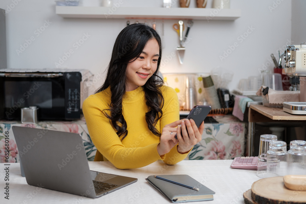 Video Conference. Portrait of cheerful Asian woman having web call using smartphone sitting on chair, talking and gesturing at webcam in home office. Video Conference. Portrait of cheerful Asian woman having web call using smartphone sitting on chair, talking and gesturing at webcam in home office.