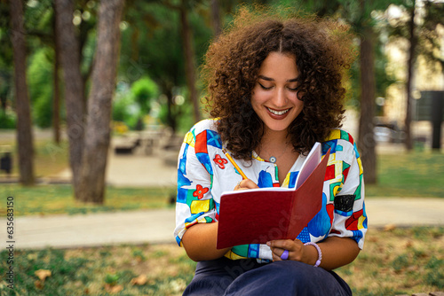 Female student with a notebook in park