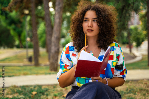 Female student with a notebook in park