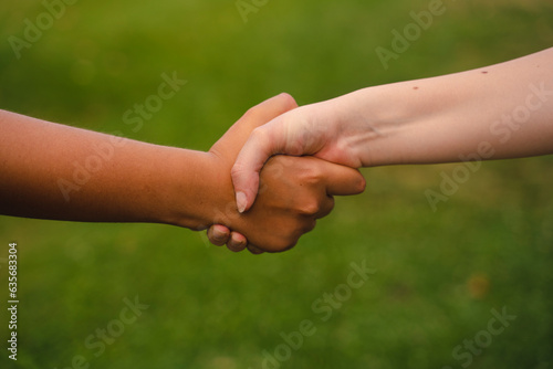 Two females shaking hands, diversity