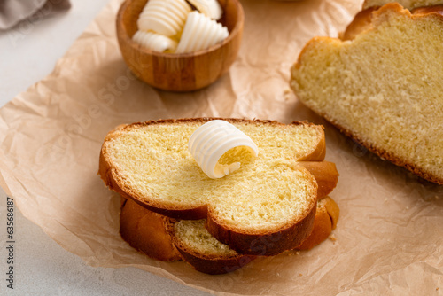 Freshly baked hallah sliced with butter and honey photo