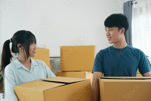 Asian young happy new married couple moving to their new house or real estate.