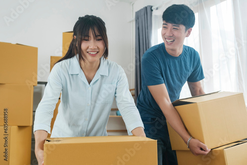 Asian young happy new married couple moving to their new house or real estate. photo