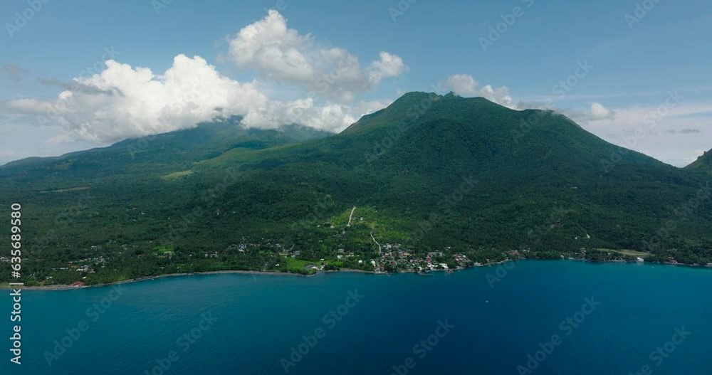 Camiguin Island with deep blue water. Blue sky and clouds. Philippines. Camiguin Island with deep blue water. Blue sky and clouds. Philippines.