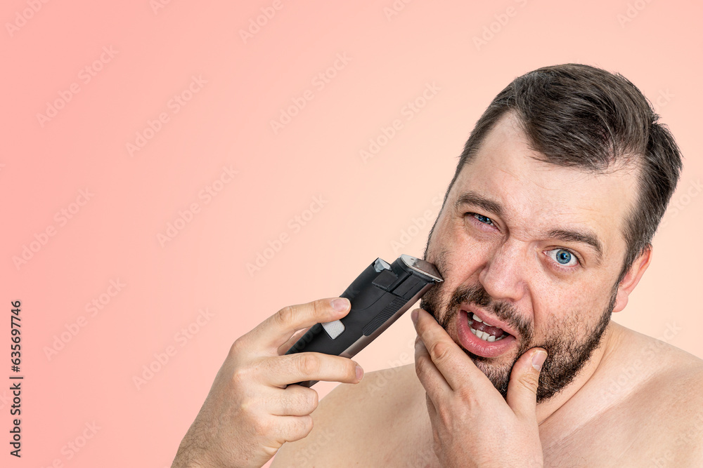 unshaven young man perfect skin hold electric razor shaving, isolated. Skin care healthcare cosmetic procedures concept. Grooming for the modern man. handsome man using electric razor unshaven young man perfect skin hold electric razor shaving, isolated. Skin care healthcare cosmetic procedures concept. Grooming for the modern man. handsome man using electric razor