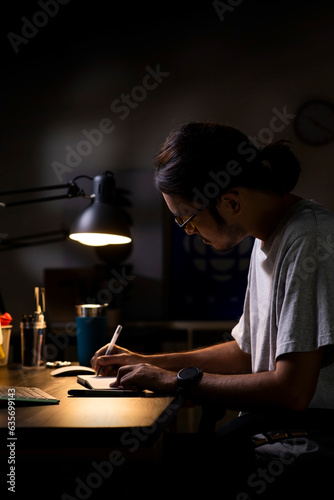 Asian man graphic designer working on computer drawing sketches logo design. The concept of a new brand. Professional creative occupation with idea.