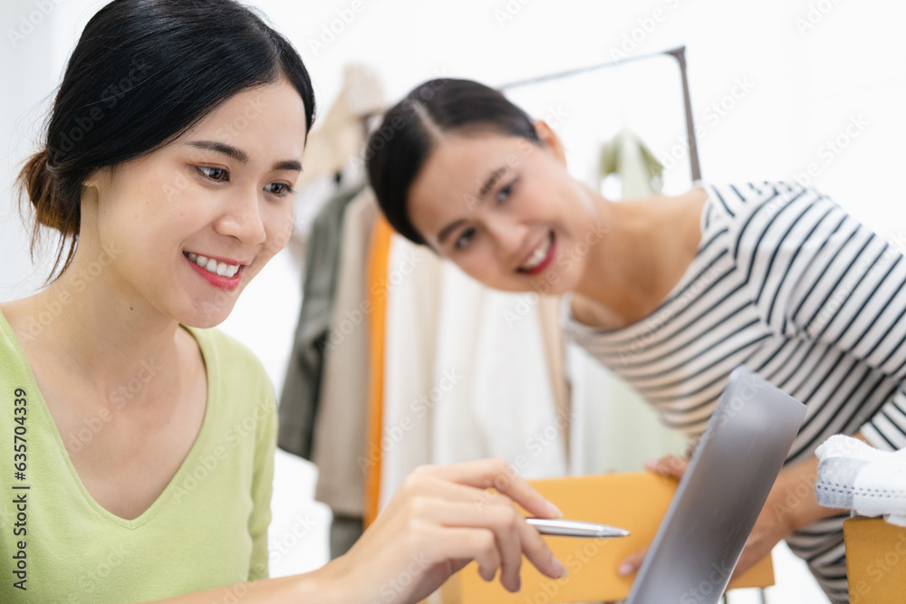 Young woman Online seller owner working for e-business commerce. Business owner checking and packing online order to delivery during sale seasonal.Online Shopping and e-Commerce concept.