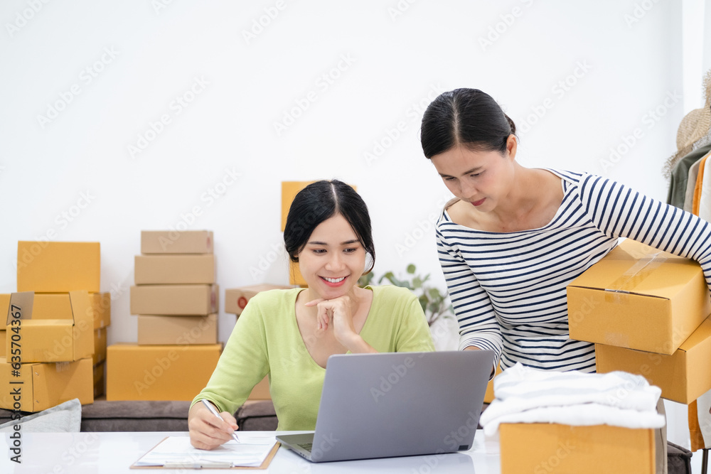 Young Women happy after new order from customer, business owner working at home office packaging on background. online shopping SME entrepreneur or freelance working concept. Young Women happy after new order from customer, business owner working at home office packaging on background. online shopping SME entrepreneur or freelance working concept.