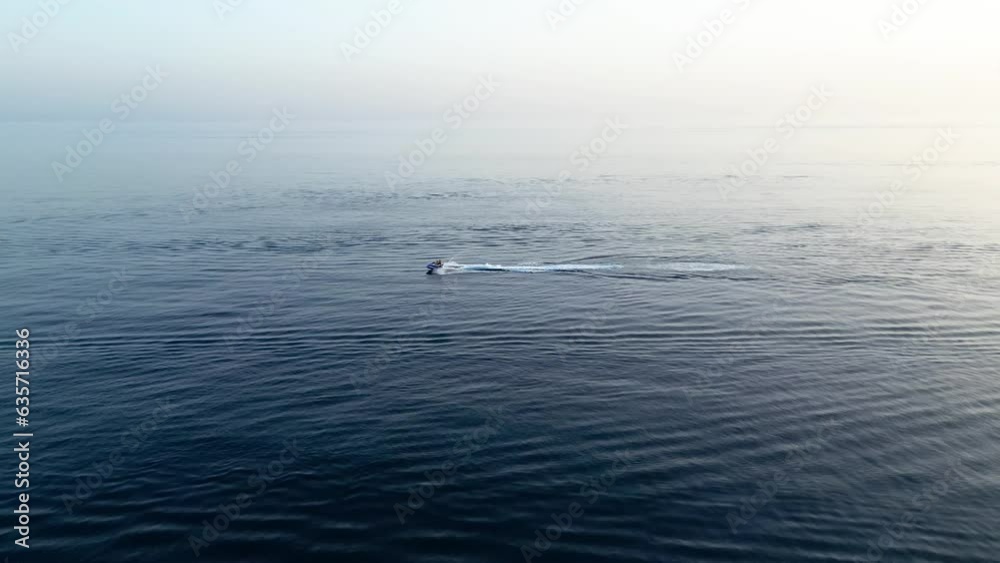 Jet ski riding on the sea at sunset on slow motion Jet ski riding on the sea at sunset on slow motion