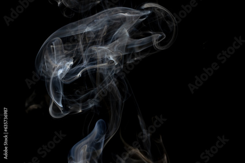Fototapeta Naklejka Na Ścianę i Meble -  White clouds of smoke with copy space on black background