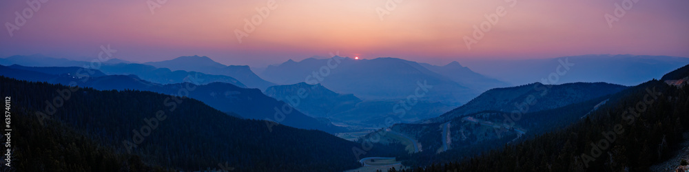 Panorama overlooking sunset of Dead Indian Pass near Cody, Wyoming during the Canada wildfires in spring of 2023
