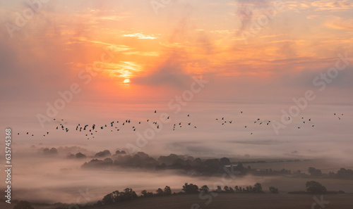 Misty morning sunrise from Bo Peep hill on the south downs east Sussex south east England UK