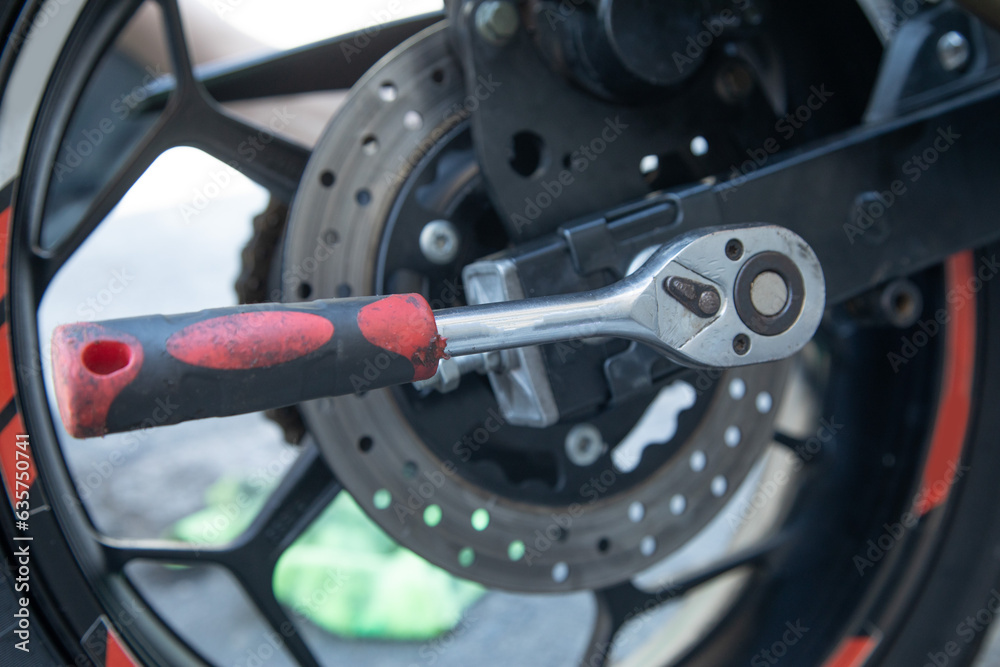 Wrench near the motorcycle vehicle. Maintenance, repair motorcycle Wrench near the motorcycle vehicle. Maintenance, repair motorcycle