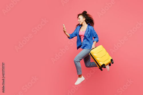 Traveler woman wearing blue casual clothes hold bag mobile cell phone isolated on plain pastel pink background. Tourist travel abroad in free spare time rest getaway. Air flight trip journey concept. #635755737