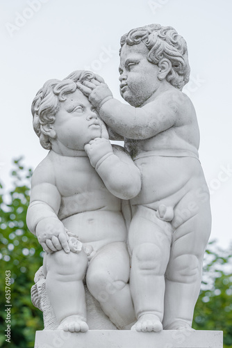 Potsdam, Germany - Old sculpture of young child in the city park and gardens in historical downtown in Potsdam