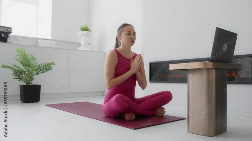 Female yoga instructor beginning online yoga training class. Beautiful woman explaining and teaching pilates and stretching in an online live video exercise course Female yoga instructor beginning online yoga training class. Beautiful woman explaining and teaching pilates and stretching in an online live video exercise course