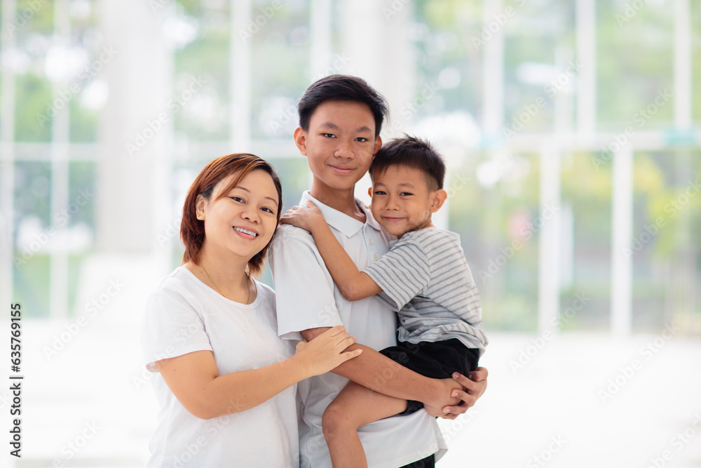 Mom and kids in restaurant. Asian family. Mom and kids in restaurant. Asian family.