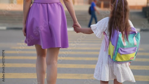 girl mother backpack zebra road photo