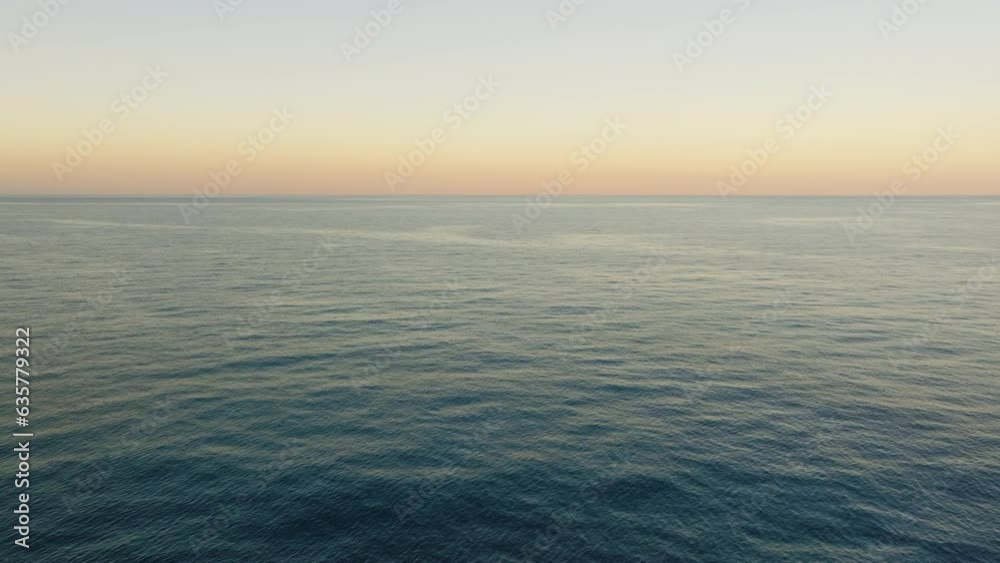 Ocean with orange sky on the horizon Ocean with orange sky on the horizon