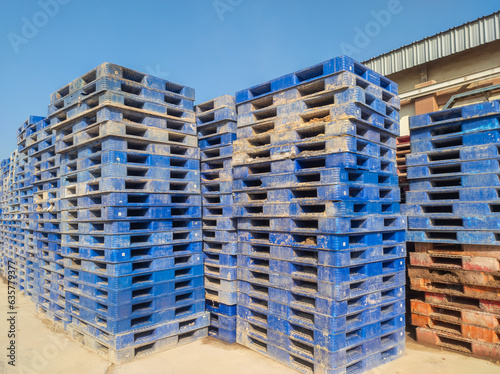 pile of dirty plastic pallets  concept photo of bankruptcy service cargo transportation industry service