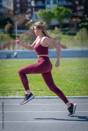 attractive girl running on running track