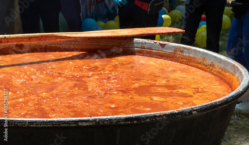 Tomato soup with pasta is a dish of Polish cuisine. Hot Zupa pomidorowa in a large cauldron at the field kitchen at a food fair. A popular soup made from grated tomatoes in their own juice.