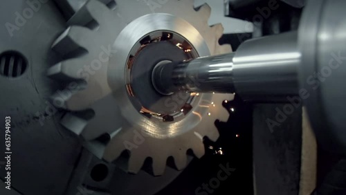 Industrial machinery is polishing the mechanism at the manufacturing facility. Industrial equipment is polishing the gear mechanism. Industrial machine is polishing the insides of the mechanism.