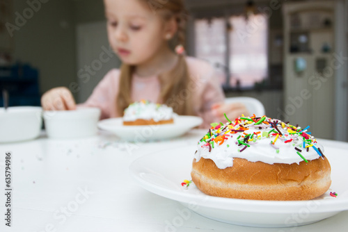 Process of decorating a cake with sweet decorations, concept of cooking of the Easter cake