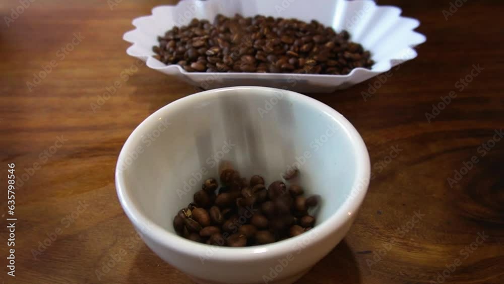 slow motion shot of falling process of Mexican coffee beans for weighing slow motion shot of falling process of Mexican coffee beans for weighing