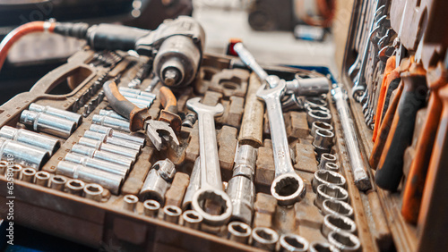 Dirty set of tools and wrenches close-up in box. Technical service station for car. Tool to repair the car or replace automotive spare parts, auto parts.