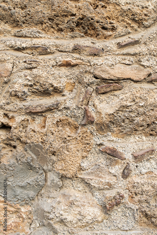 beige-colored stone wall. texture background