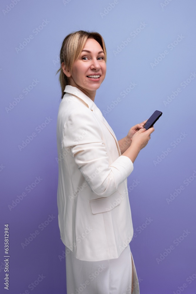 pretty slim young caucasian blondie lady in a white jacket and dress on a plain background pretty slim young caucasian blondie lady in a white jacket and dress on a plain background
