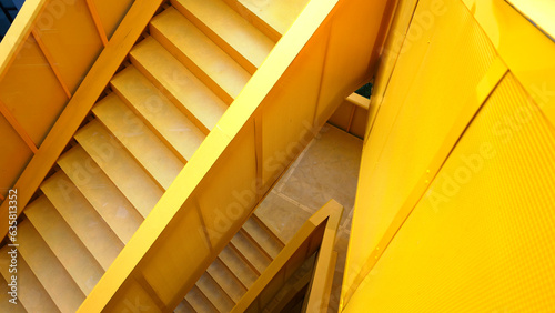 iron yellow staircase outside contemporary building.