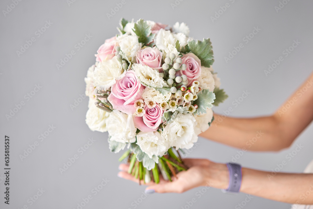 Bridal bouquet. The bride's . Beautiful of white flowers and greenery, decorated with silk ribbon.