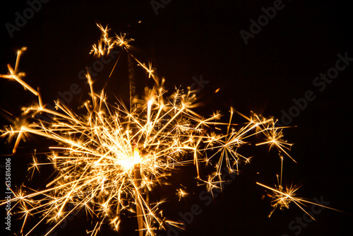 Sparks lit at Christmas and New Year party on black background.