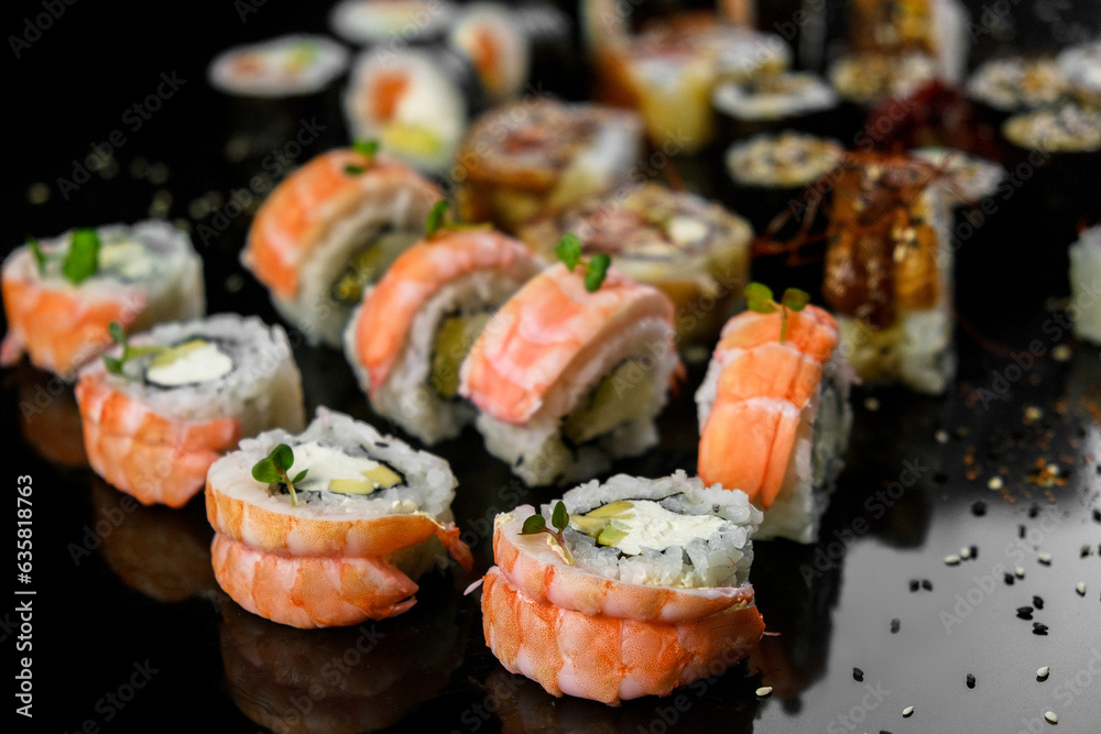 Sushi set on a black background. Fresh variety of rolls in a Japanese restaurant. Eastern cuisine. Sushi set on a black background. Fresh variety of rolls in a Japanese restaurant. Eastern cuisine.