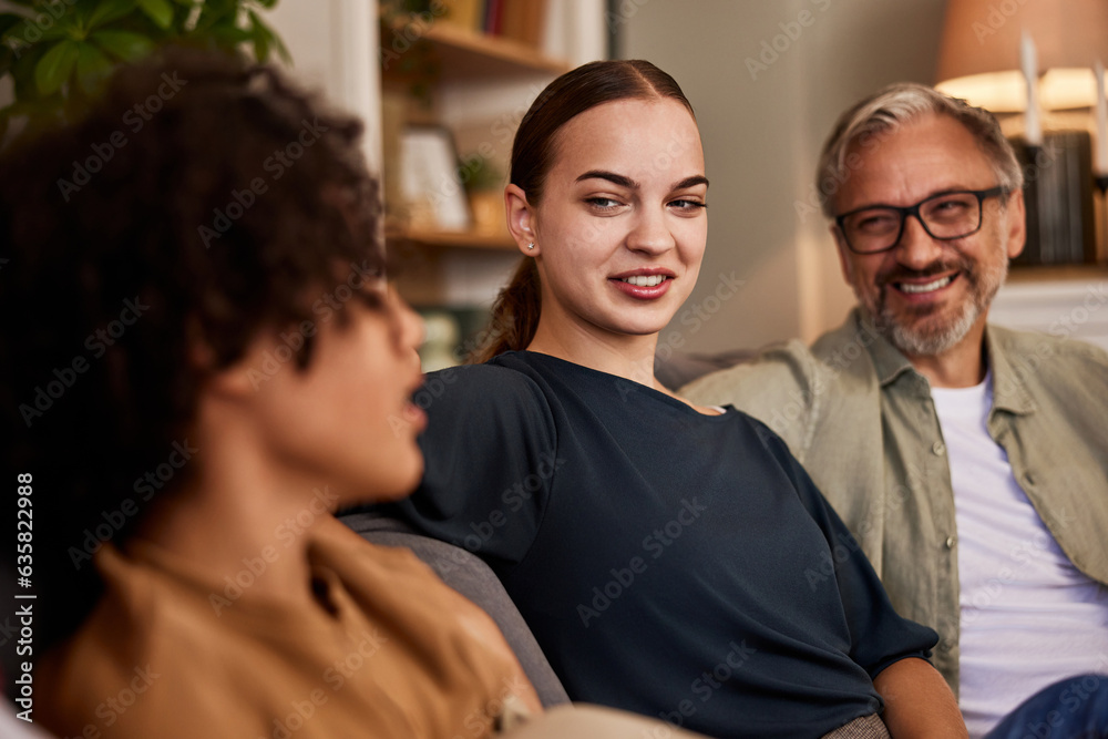 Fototapeta premium Diverse family sitting on a couch, having great time together.