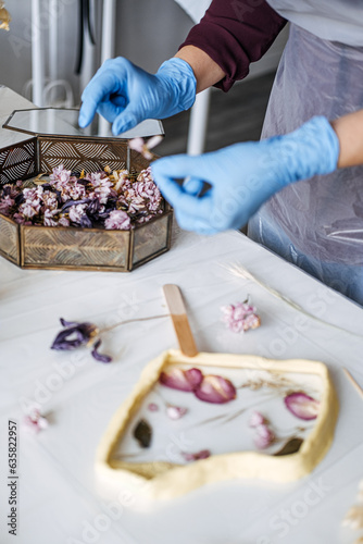 Side hustle, Money-Making Crafts, DIY Crafts To Create and Make Money. Epoxy Resin Art. Creating Art with Resin on workshop. The art process of creating epoxy resin handmade staff in art studio.