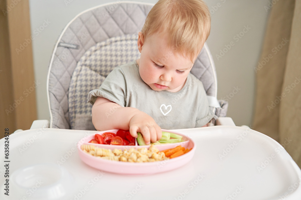 Cute child eats healthy food pasta and vegetables steamed,. Portraits