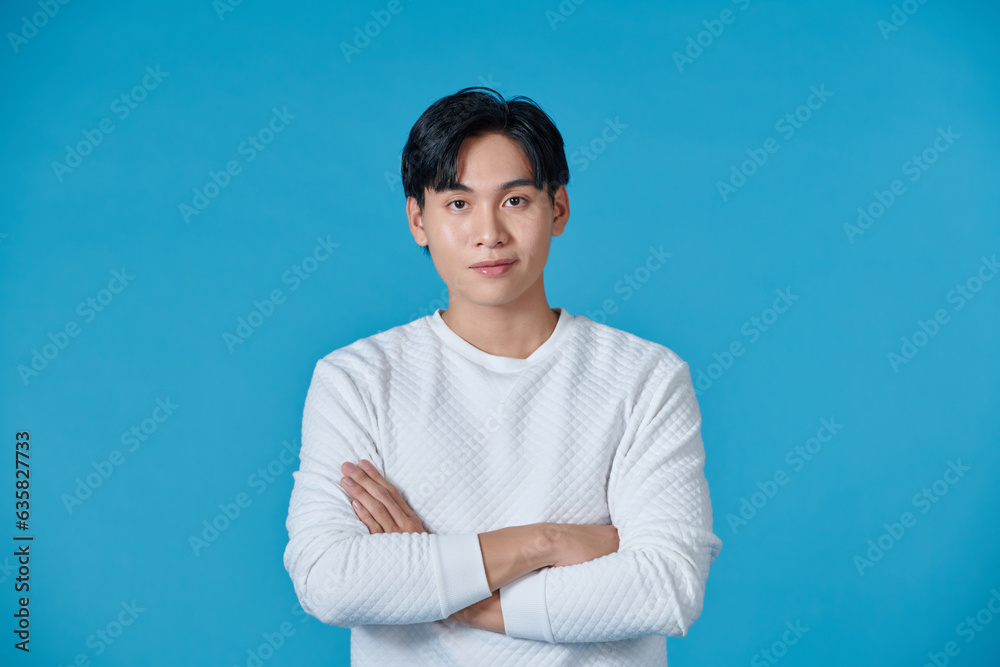 Young asian man posing on a blue background Young asian man posing on a blue background