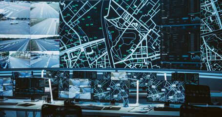 Empty Modern Monitoring Office With Big Digital Screen And Working Places of Employees With Desktop Computers and Displays. Screens Showing a City Map Animation and Surveillance Data
