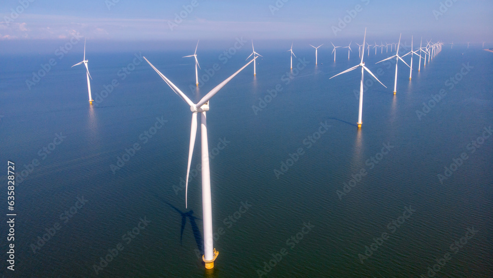 Offshore Windmill farm in the ocean Westermeerwind park , windmills isolated at sea on a beautiful bright day Netherlands Flevoland Noordoostpolder Offshore Windmill farm in the ocean Westermeerwind park , windmills isolated at sea on a beautiful bright day Netherlands Flevoland Noordoostpolder