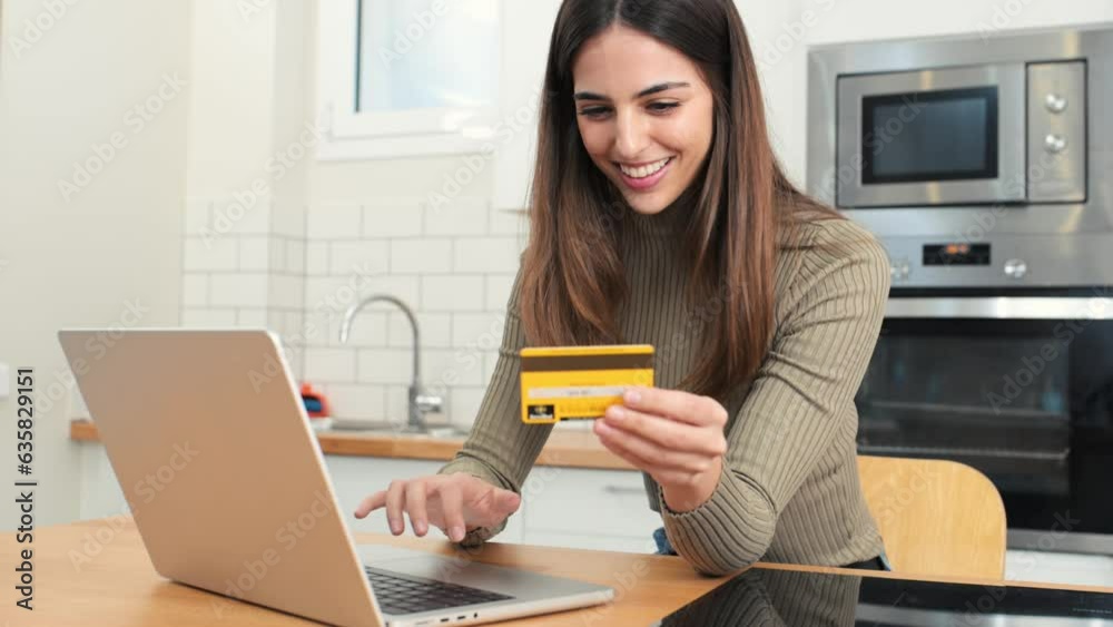 happy young attractive woman shopping online with a laptop computer using a credit card. e-commerce, business concept happy young attractive woman shopping online with a laptop computer using a credit card. e-commerce, business concept