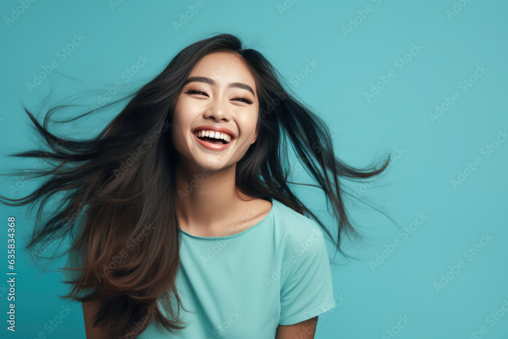 Beautiful Young Happy Thai Woman On Blue Background Beautiful Young Happy Thai Woman On Blue Background