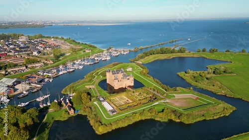 Aerial View on Muiderslot Castle in Muiden, Netherlands, panning around. The Castle dates from the late 14th Century. photo