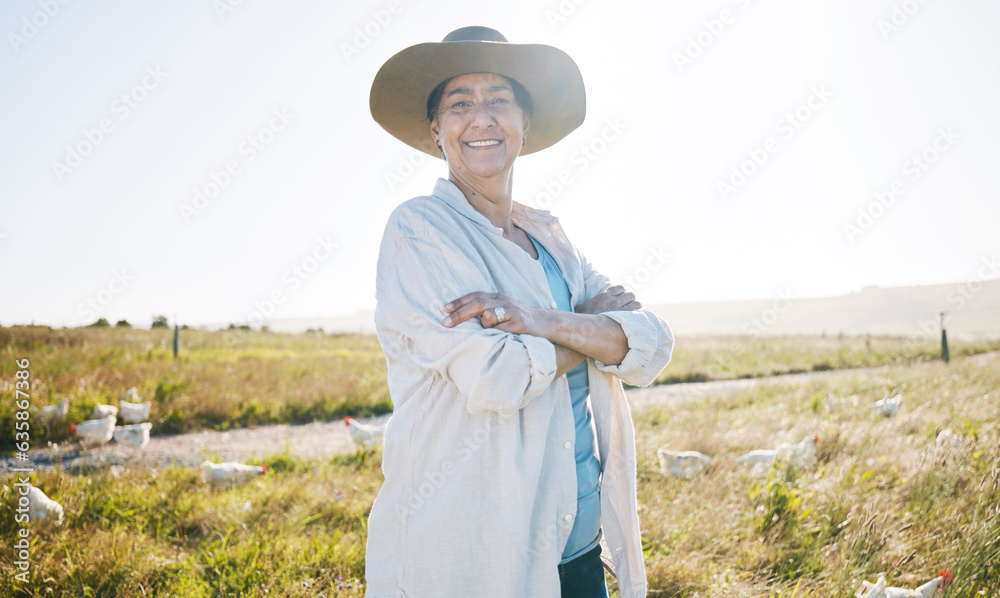 Farmer, mature woman and agriculture, arms crossed on field and sustainability, land and livestock. Chicken farm, agro business and confidence, countryside and environment with nature and portrait