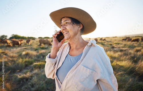 Woman, farmer and phone call in countryside with cow, person and cattle on farm with smile for live stock in nature. Happy, female worker or social network, connection and communication in rural land