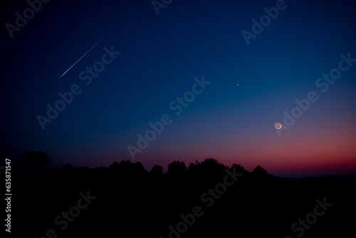 Crescent Moon, falling star, planet conjunction and landscape scenery silhouettes.