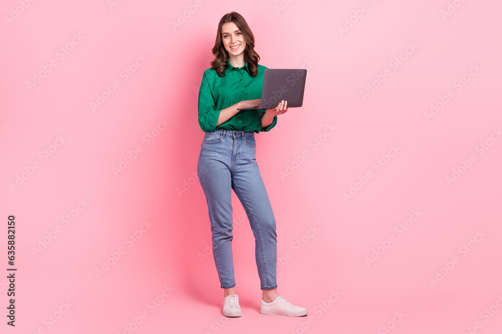 Full body portrait of positive lovely lady hold use wireless netbook coworking isolated on pink color background Full body portrait of positive lovely lady hold use wireless netbook coworking isolated on pink color background
