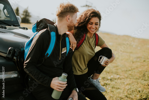 Young couple relaxing by a ...